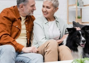 Couple speaking. Woman petting dog.