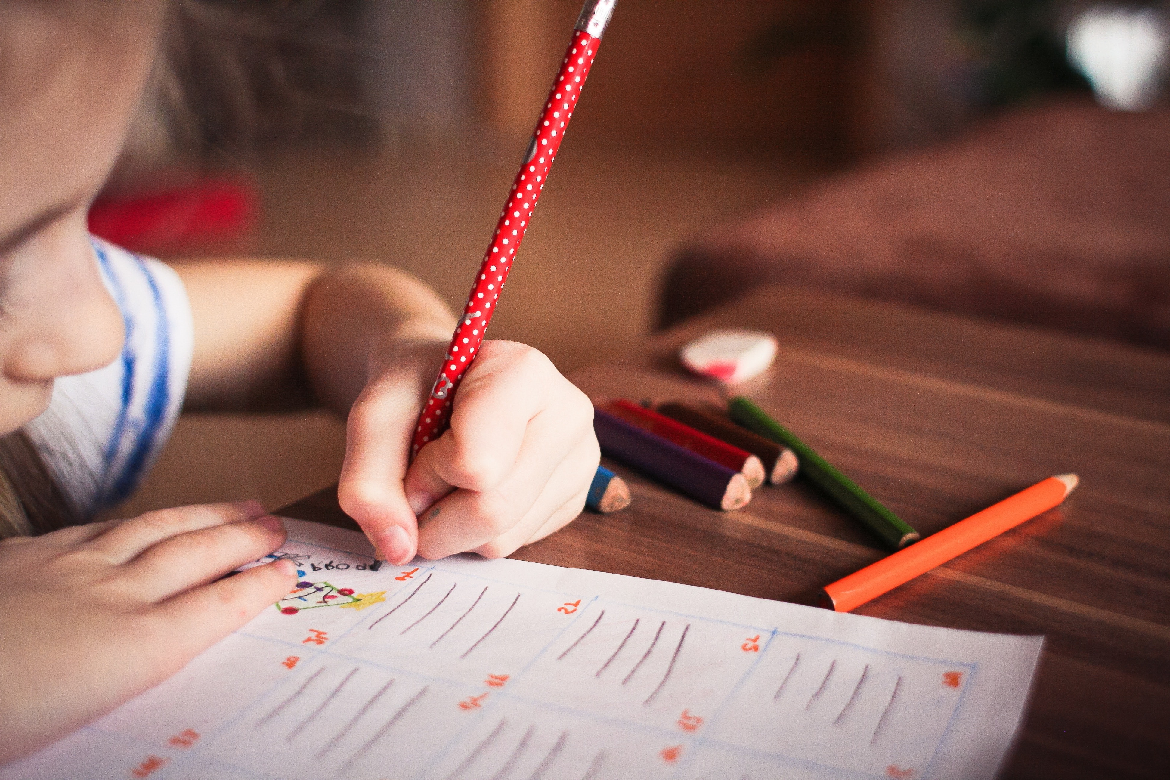 Child writing on paper.