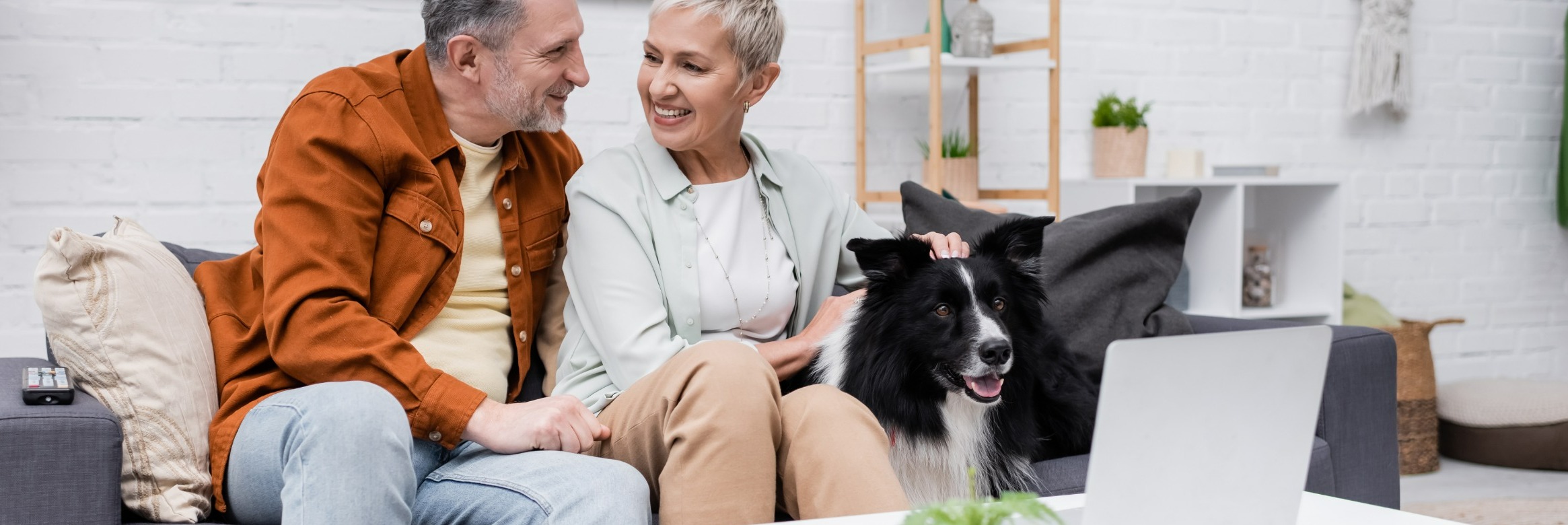 Couple speaking. Woman petting dog.