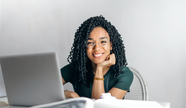 Young woman smiling while using computer