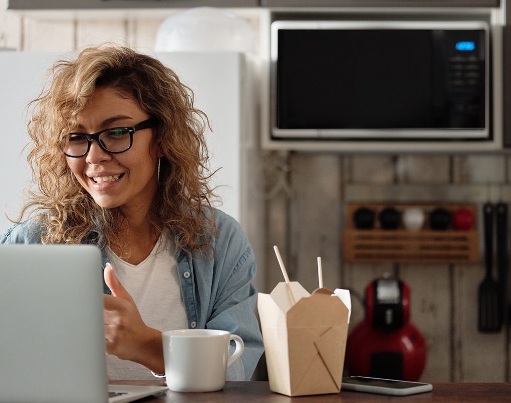 Woman using laptop in kitchen