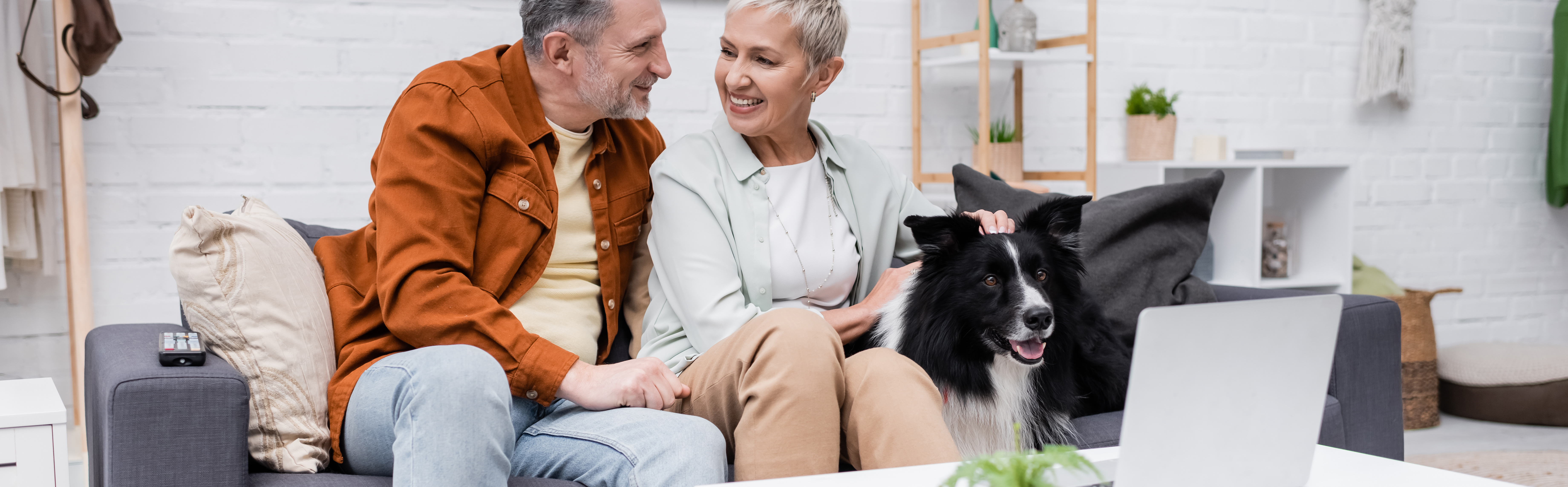 Couple speaking. Woman petting dog.