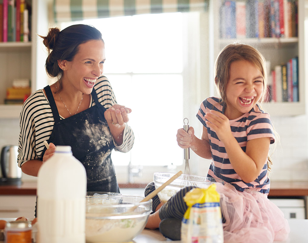 Mother and daughter baking in kitchen