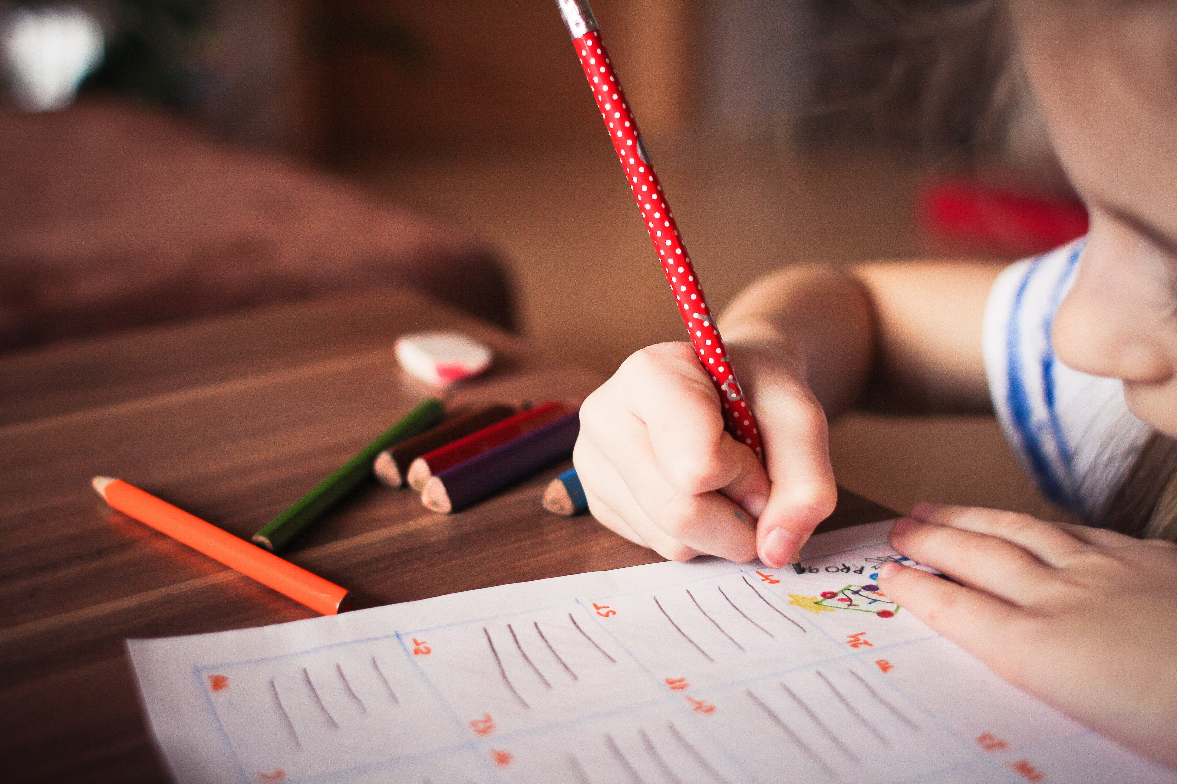 Child writing on paper.