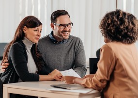 couple speaking with a banker.