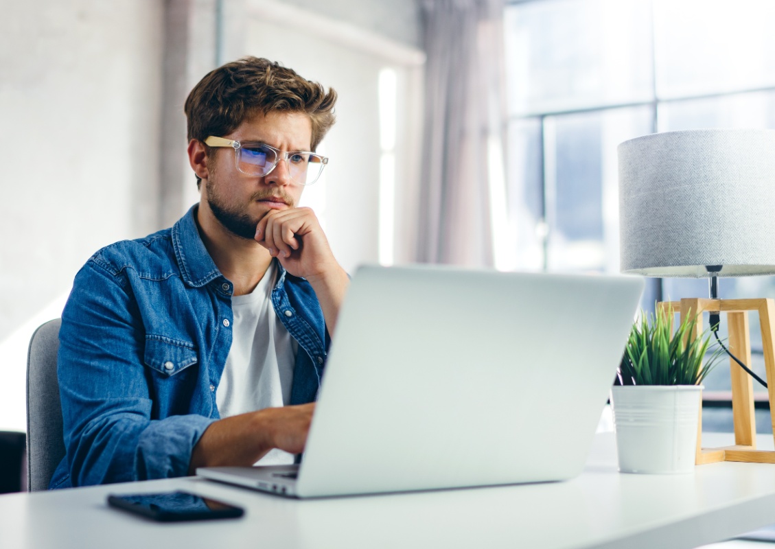 Guy with glasses looking at laptop