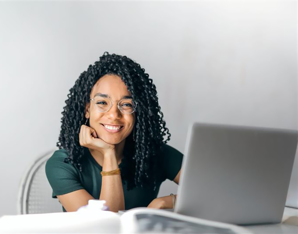 Young lady using laptop in office