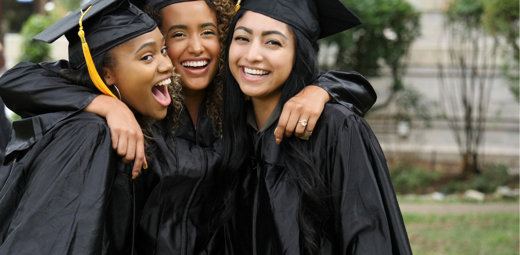 Three girls in college graduation outfits. 