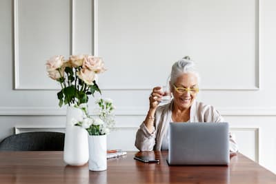 Older woman looking at laptop.