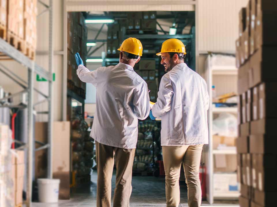 Father and son walking through business warehouse