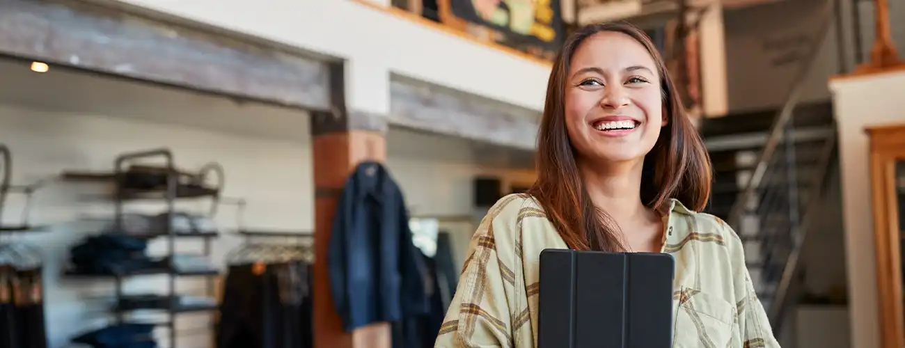 business owner smiling with ipad