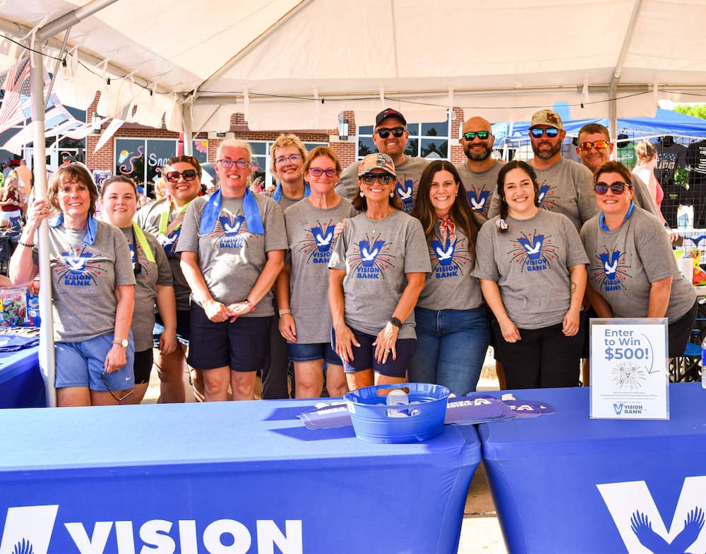 DSC_0087 Vision Bank Employees smiling at Arbuckle Beats and Bites event.
