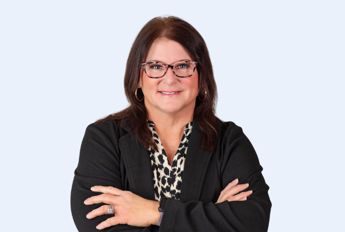 Wendy West, Shawnee branch manager, headshot on blue background. 