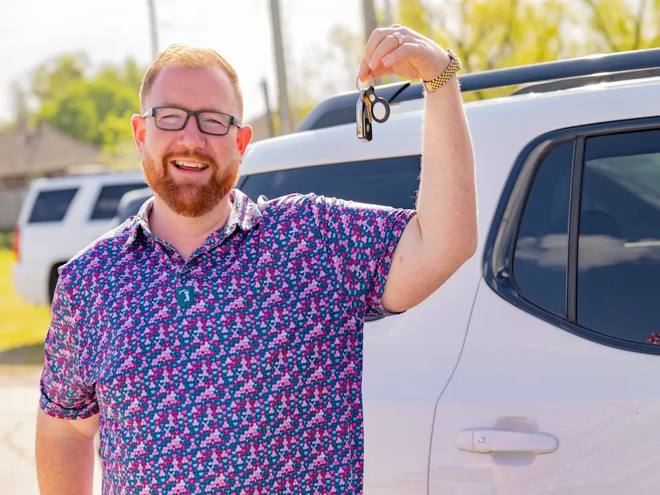 Customer holding keys at car dealership Customer holding keys at car dealership