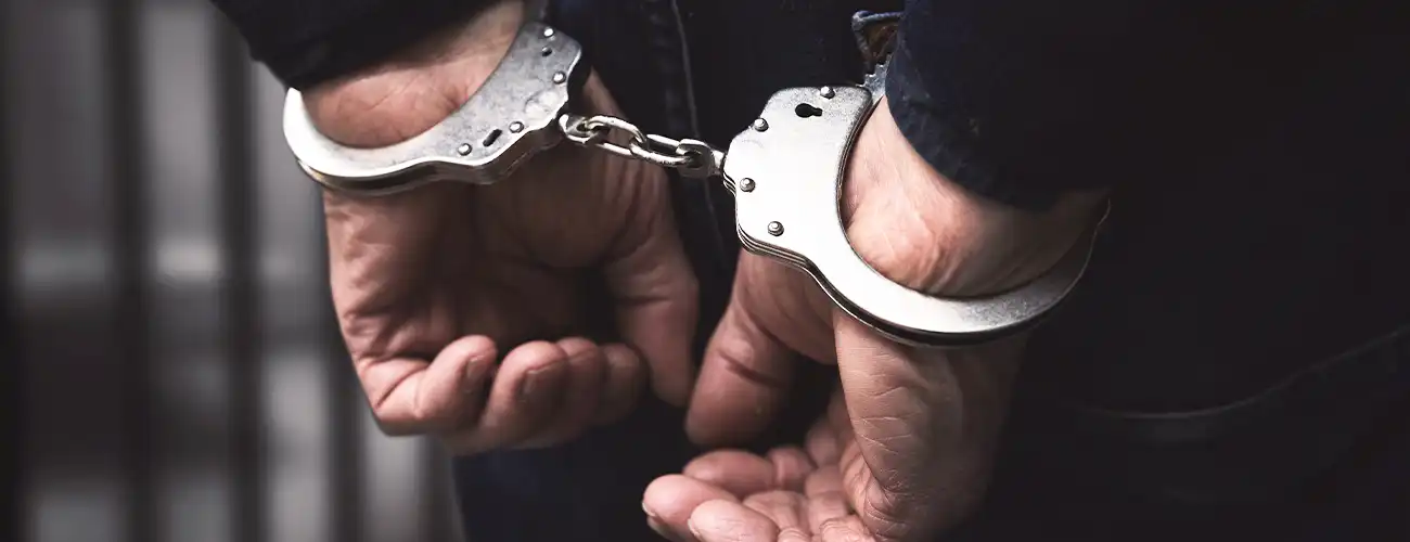 person in handcuffs