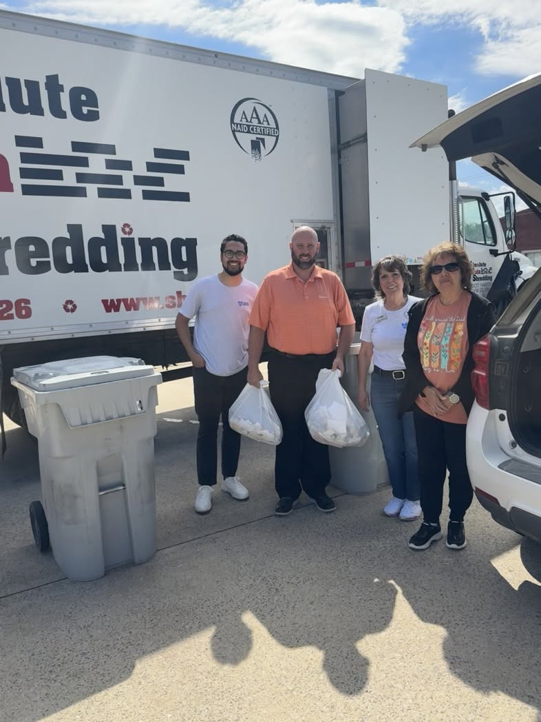 Vision Bank employees unloading car for Shred Day